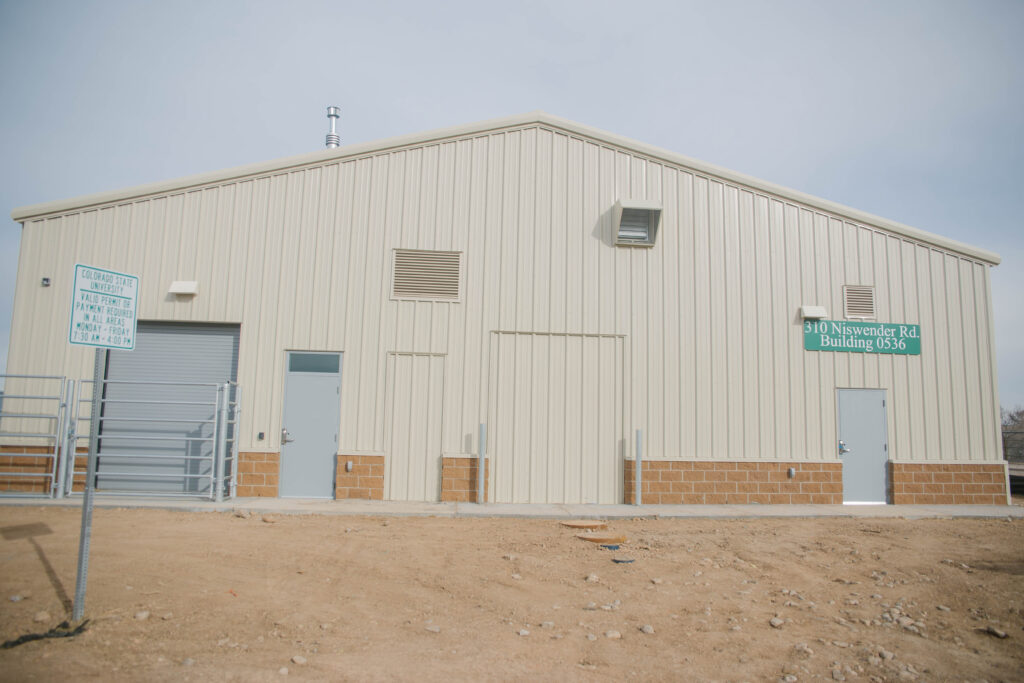 tan building in front of dirt ground