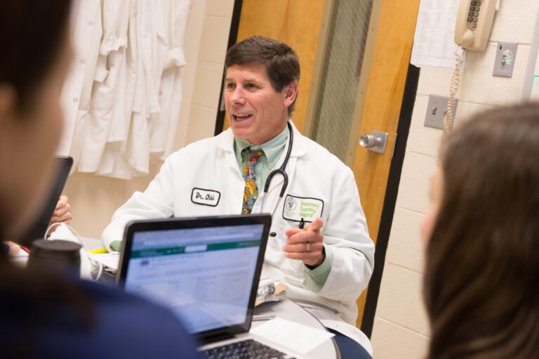 Colorado State University Department Clinical Sciences associate professor of internal medicine Craig Webb talks over cases with veterinary students and residence in small animal medicine rounds