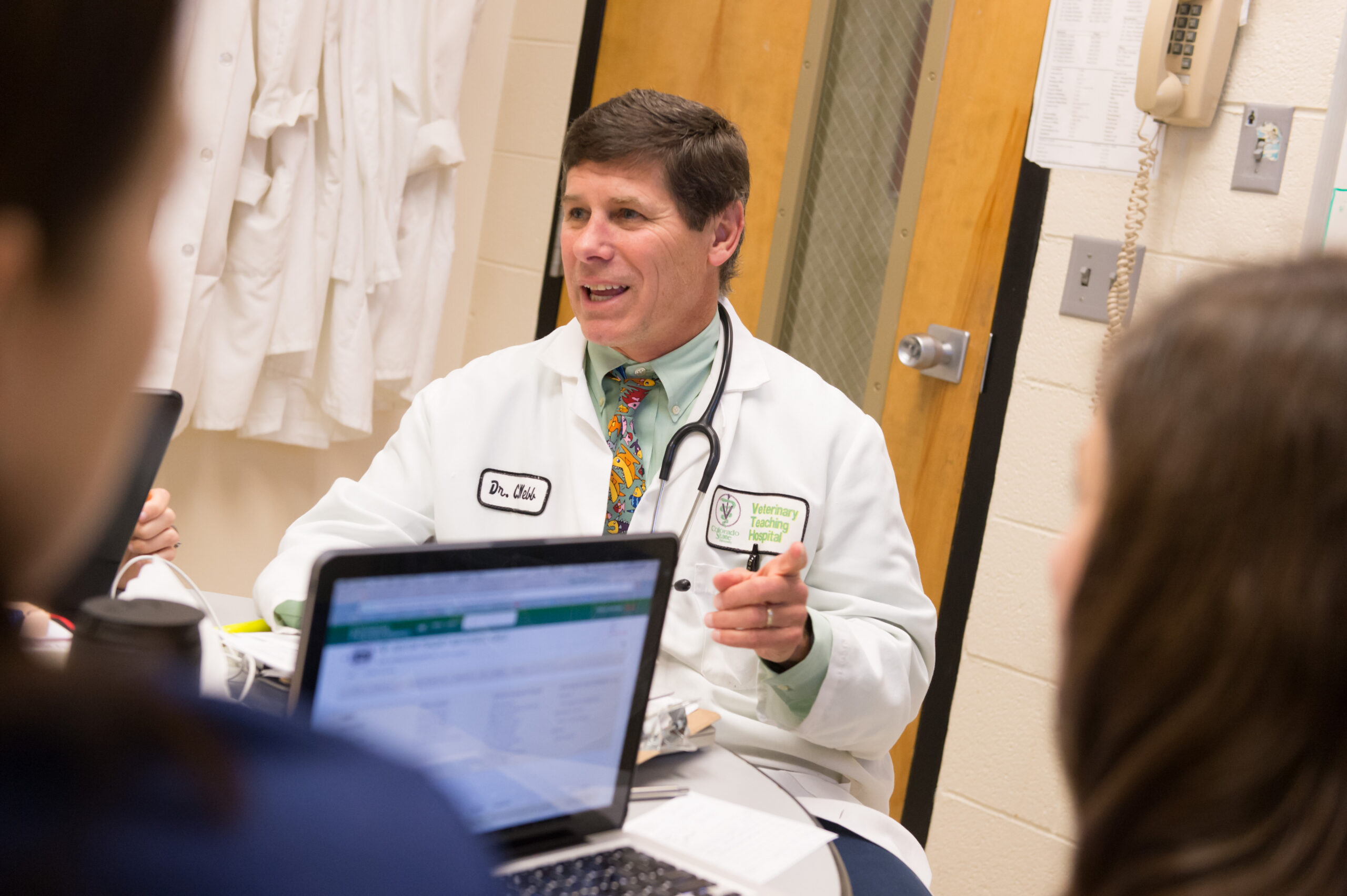 Colorado State University Department Clinical Sciences associate professor of internal medicine Craig Webb talks over cases with veterinary students and residence in small animal medicine rounds